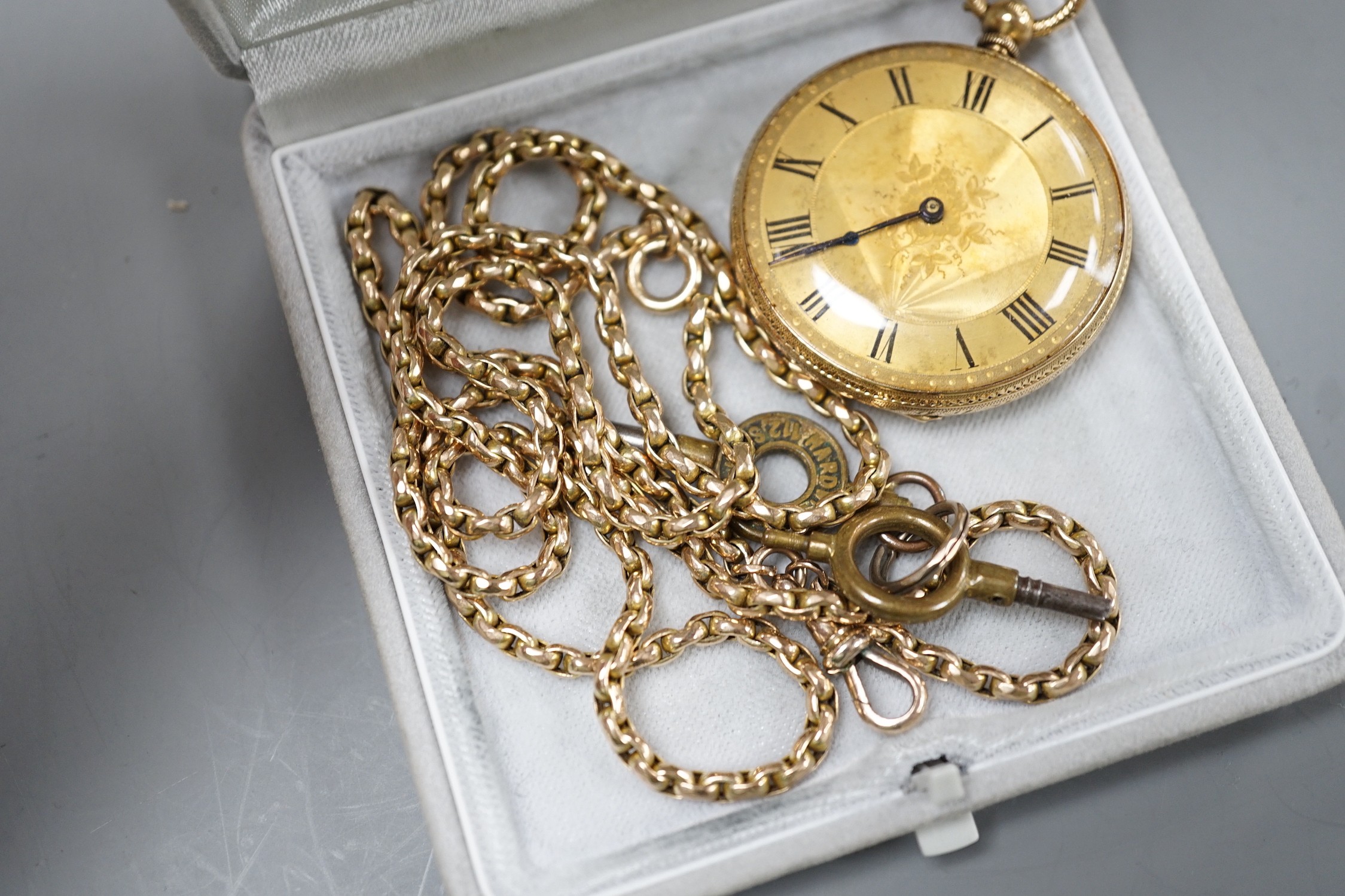 An 18k engraved gold open faced keywind pocket watch, gross 40 grams and a 9ct chain, 20.4 grams.